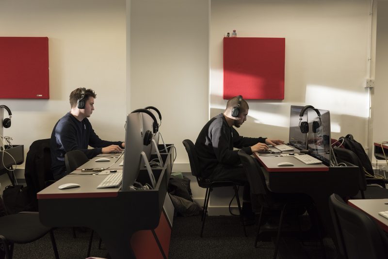 Abbey Road Institute's classroom walls feature GIK Acoustics red square 242 Acoustic Panels as students work